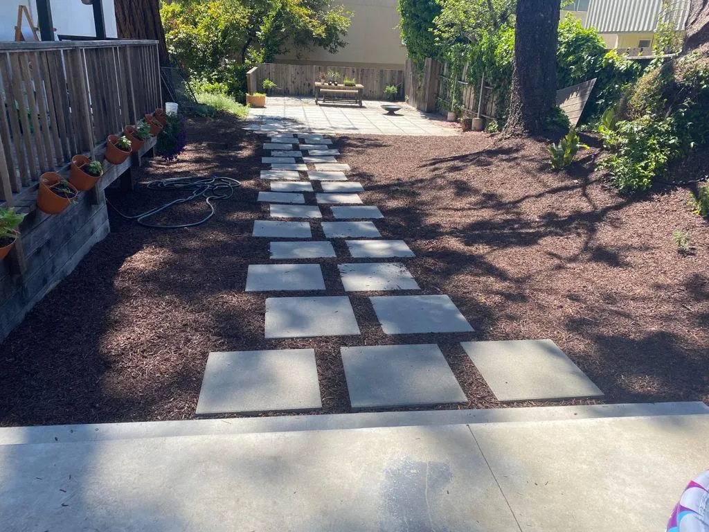 Large concrete stepping stones set in red mulch
